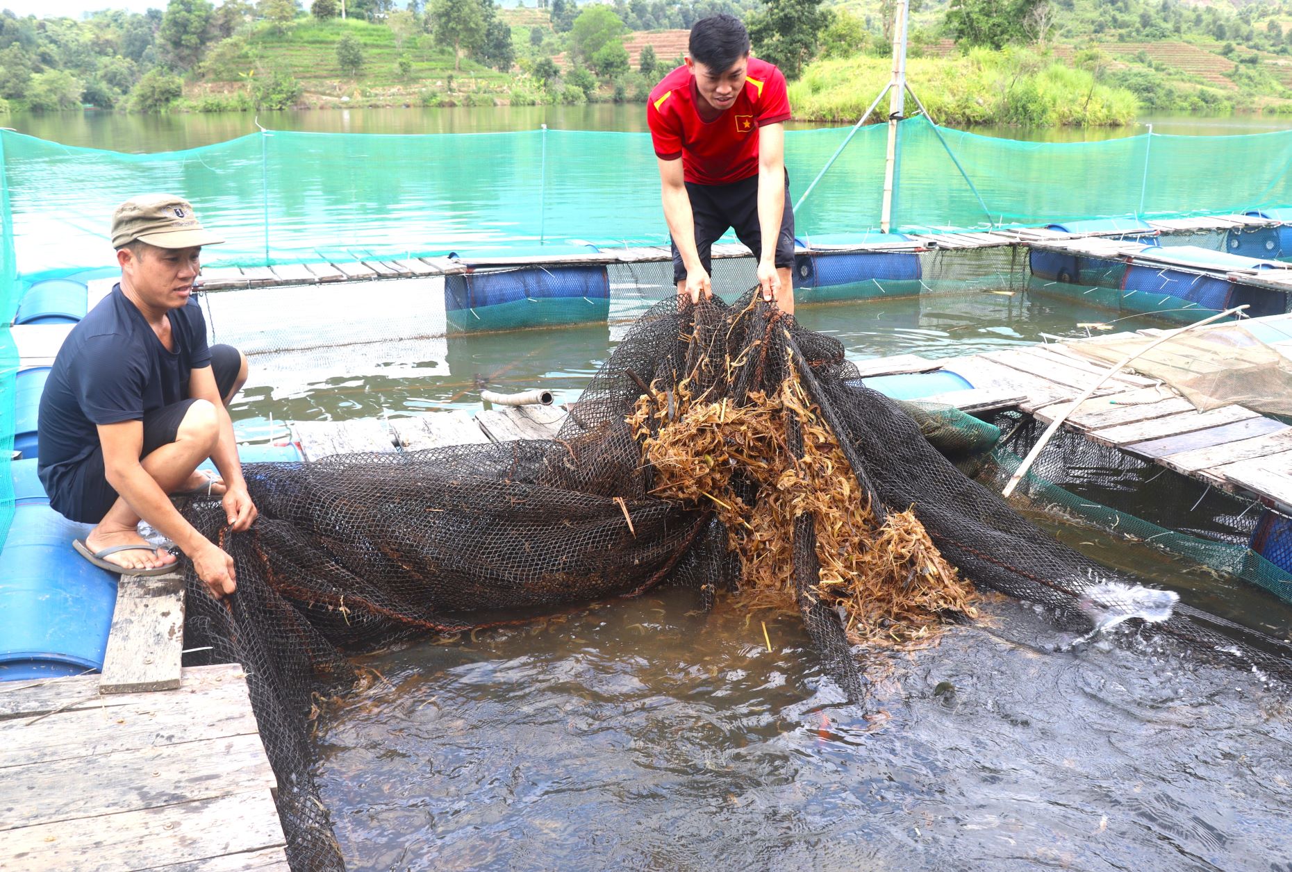 Nhờ đầu tư nuôi cá lồng, cuộc sống của anh Thần Quang Kim (người đội mũ) ở bản Hồng Quảng 1, xã Pa Khoá đã đổi khác.